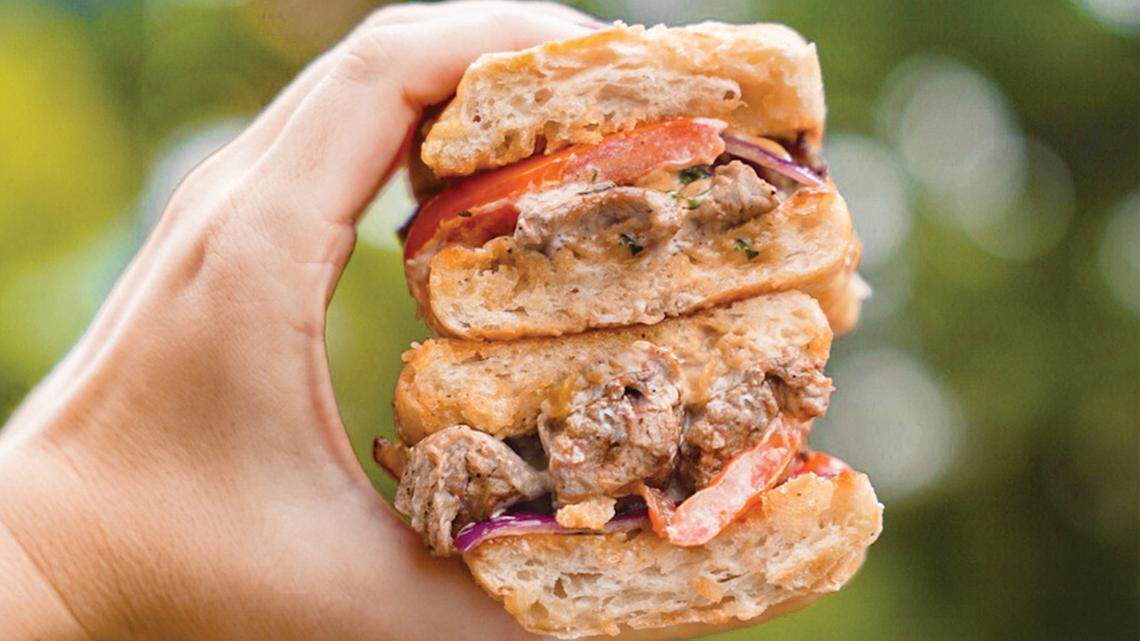 The Wow Lomito sandwich is marinated steak topped with sauteed onion, tomatoes, rocoto mayo and salsa criolla on ciabatta.