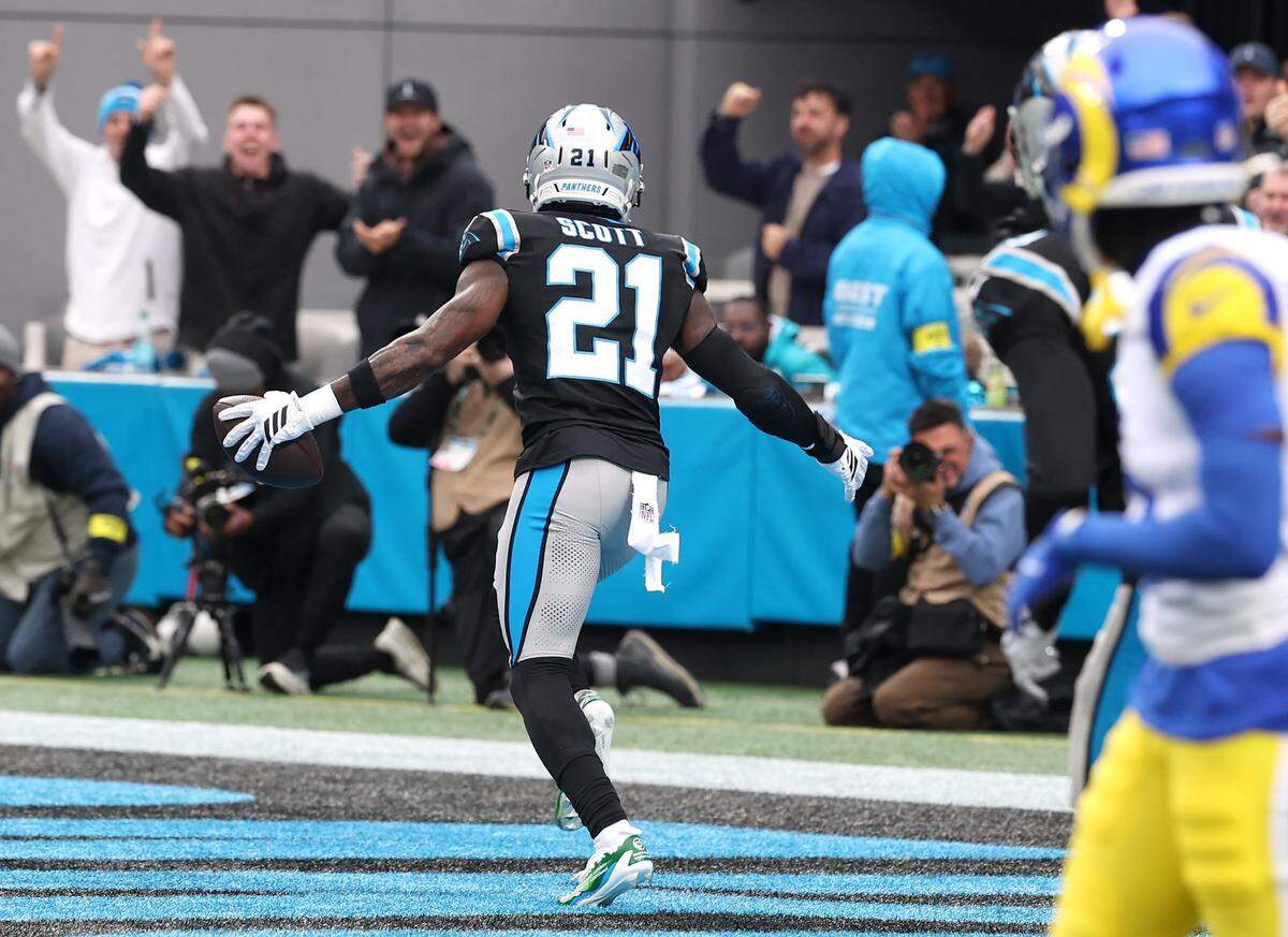 Panthers safety Nick Scott celebrates his interception of a pass by Rams quarterback Matthew Stafford in the end zone on Nov. 30, 2025, at Bank of America Stadium in Charlotte. The Panthers defeated the Rams 31-28.