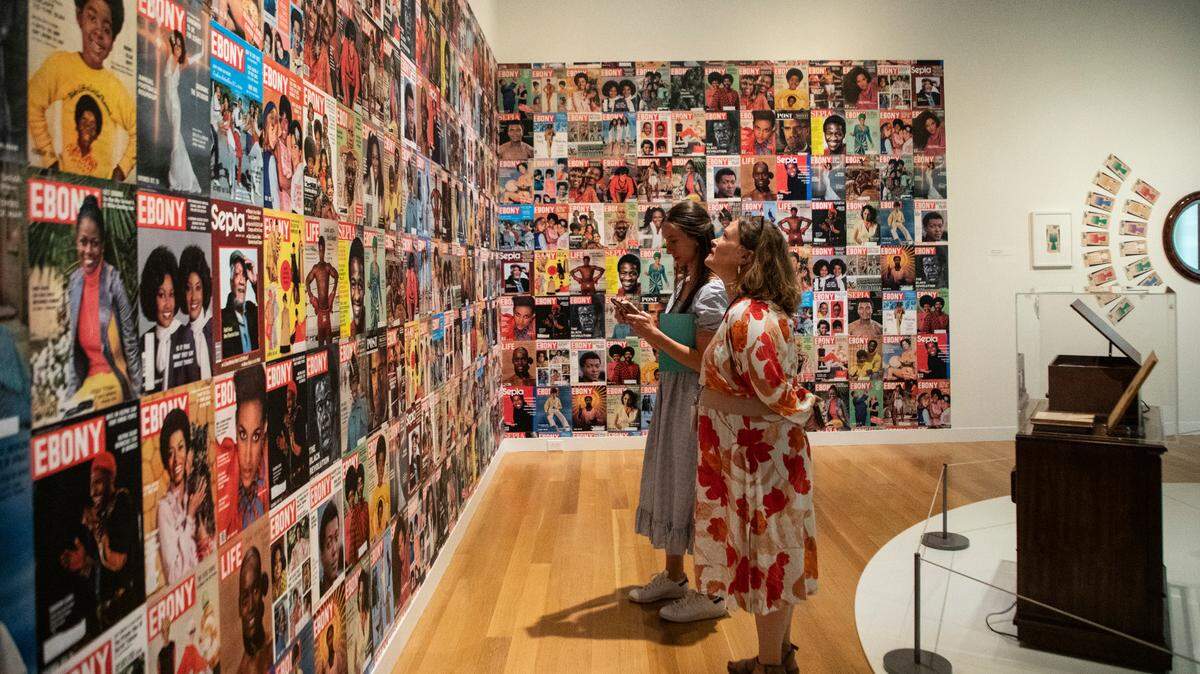 Two individuals view the wall of magazine covered that Cheryse & Christopher Terry have collected at The Mint Museum’s new exhibit, The Vault, in Charlotte, NC.