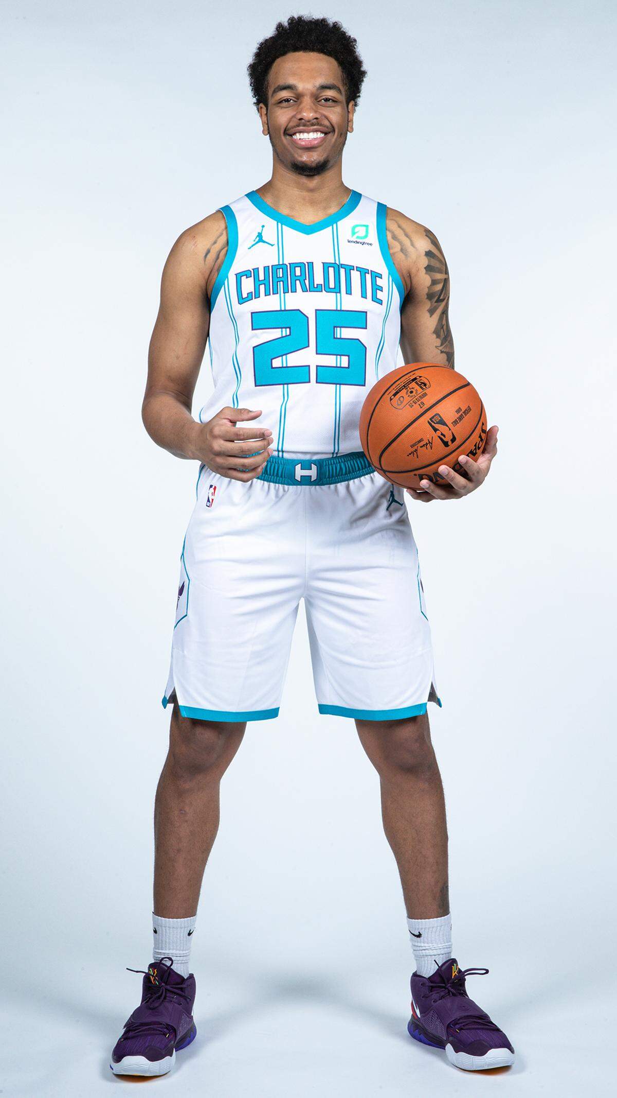 PJ Washington modeling the Charlotte Hornets' new uniforms for the 2020-21 season.