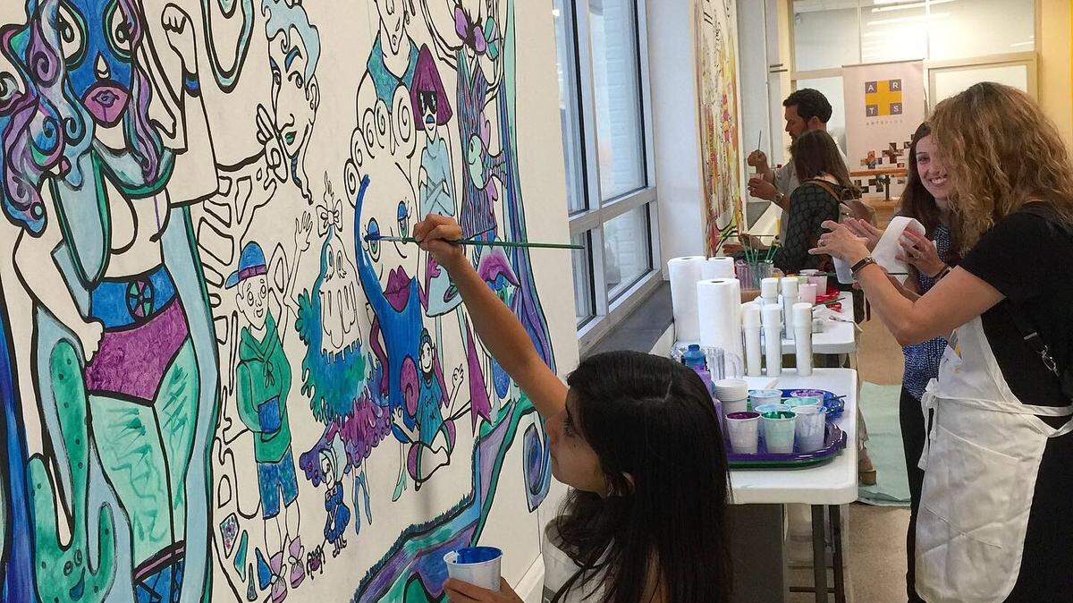 Arts+ has a new experimental workspace called The Bridge. It’s near NoDa at 4100 Raleigh Street, next door to the Charlotte Art League and within walking distance of the Blue Line stop at Sugar Creek Road.. The children pictured helped paint two murals there.