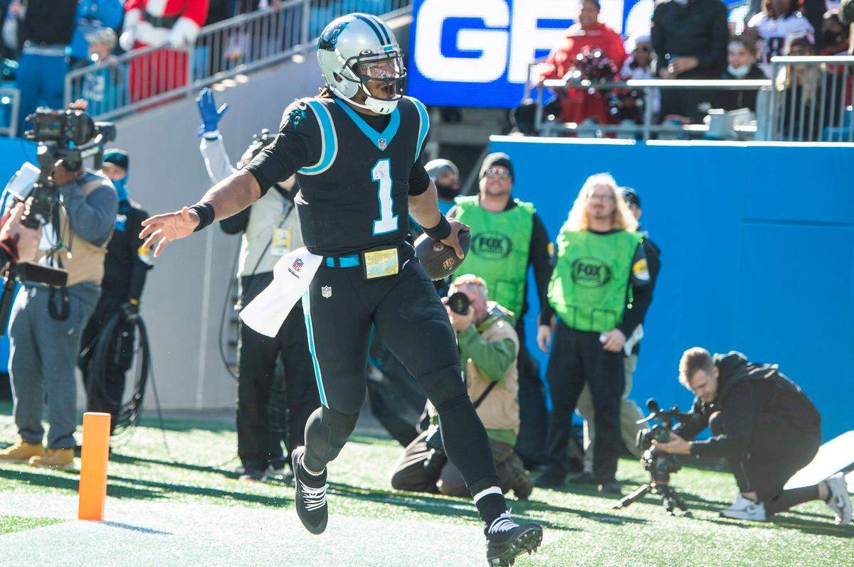 Panthers quarterback Cam Newton runs into the end zone for a touchdown in the first quarter during the game against the Atlanta Falcons at Bank of America Stadium on Sunday, December 12, 2021 in Charlotte, NC.