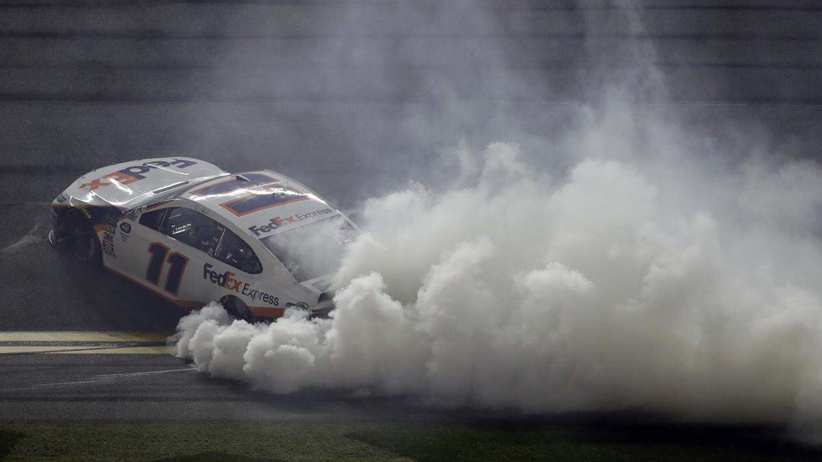 Denny Hamlin burns his tires after winning a NASCAR Daytona 500 auto race Sunday, Feb. 17, 2019, at Daytona International Speedway in Daytona Beach, Fla. (AP Photo/Chris O’Meara)