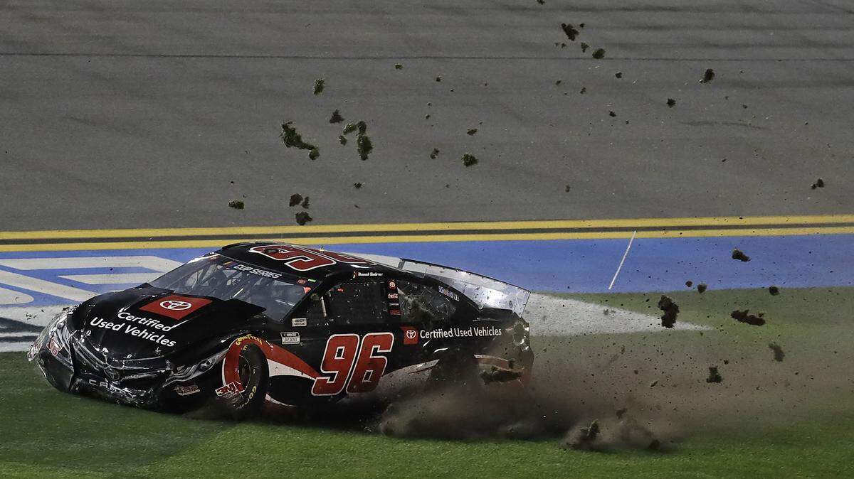 Daniel Suarez’s car kicks up grass as it slide across the infield after a crashing with Ryan Blaney’s car during a NASCAR Daytona 500 qualifying auto race Thursday, Feb. 13, 2020, at Daytona International Speedway in Daytona Beach, Fla. (AP Photo/Chris O’Meara)