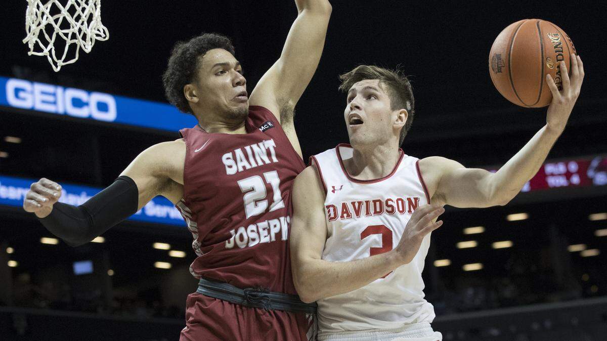 Davidson guard Jon Axel Gudmundsson (3) goes to the basket against Saint Joseph’s forward Lorenzo Edwards (21) during the first half of an Atlantic 10 Conference quarterfinal game Friday in New York.
