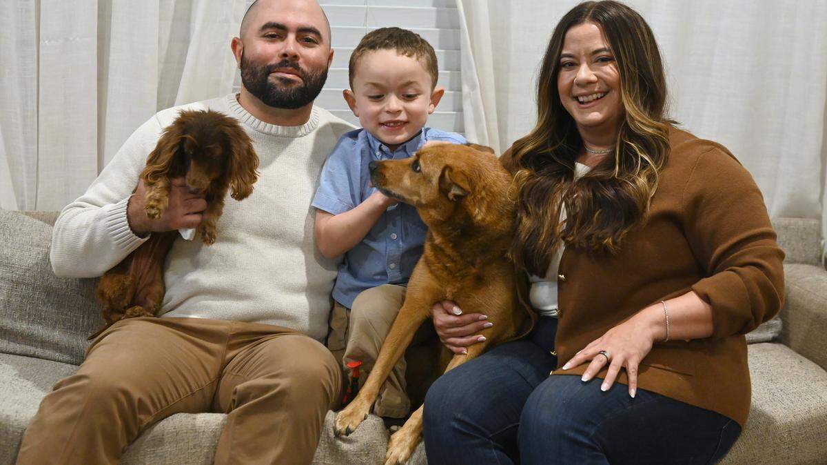 Liz Monterrey became the first Latina elected to the Charlotte-Mecklenburg Schools board this month. Here, she poses with husband, Chris, and son, Isaac. The dogs names are Baby Girl, left, and Zoey, right.
