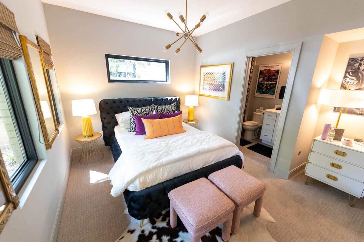A ground-level guest room includes bright decor, matching colors from the hallway.