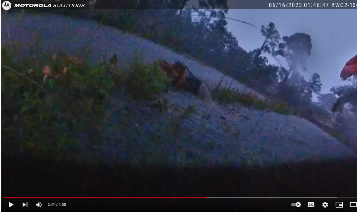 This screenshot shows the moment the Escambia County deputy emerged from the flooded pipe and saw the motorist on the other side of U.S. 98 in Florida. 