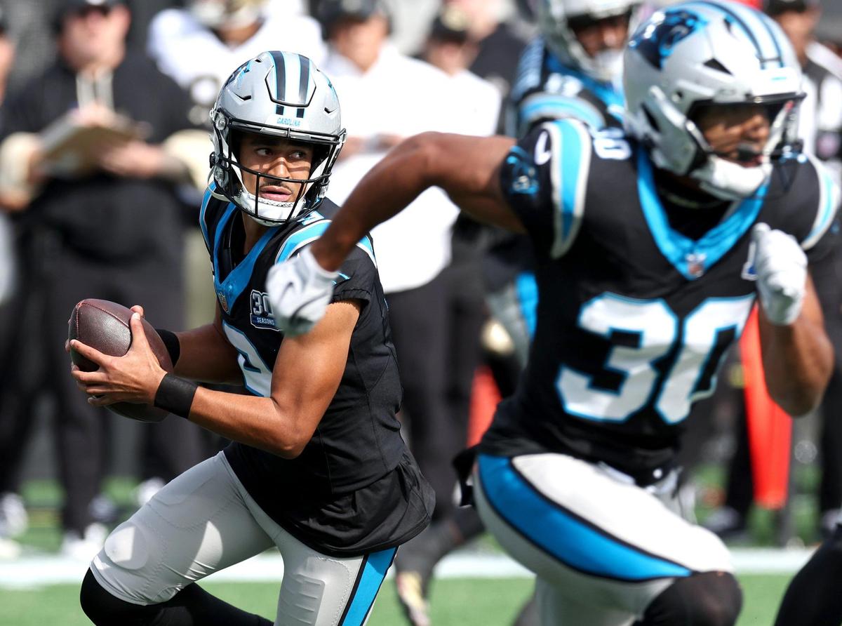 Carolina Panthers quarterback Bryce Young rushes out of the pocket looking for a receiver during action against the New Orleans Saints on Sunday, November 3, 2024.