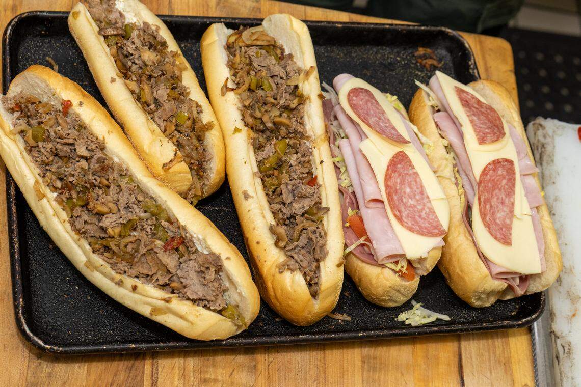 Steak Philly subs and Italiano subs await a layer of melted cheese at House of Pizza.