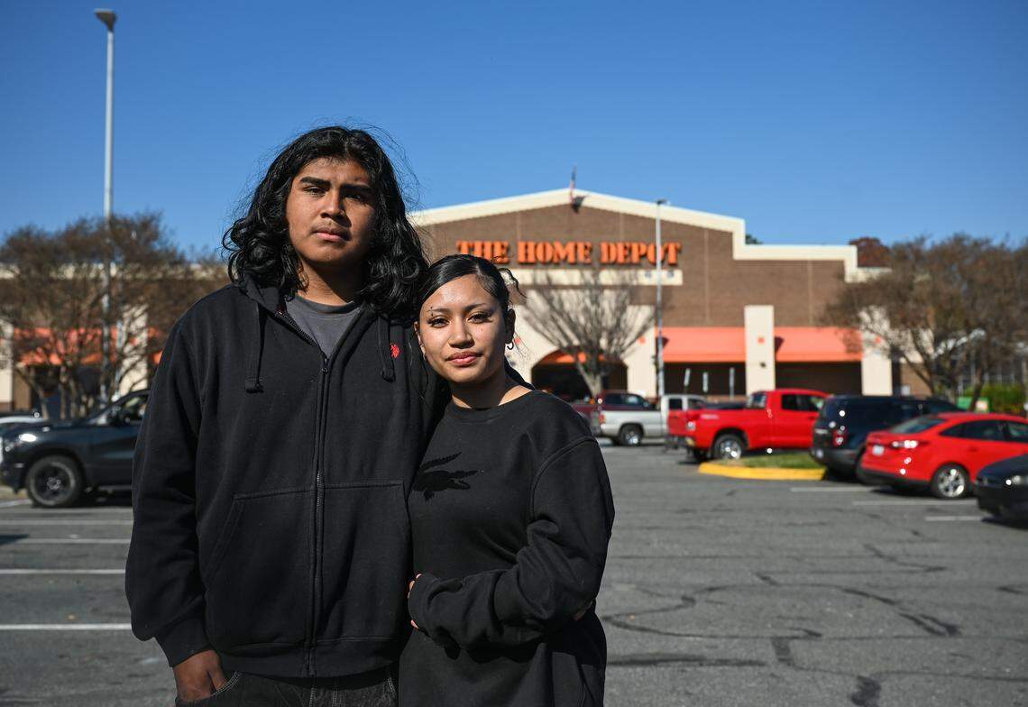 Brayan Vicente Martinez, and his girlfriend Lienarani Bermudez stand outside the Home Depot on University City Boulevard where Martinez’s older brother, Miguel Angel Garcia Martinez, snapped photos of masked agents and sent them to warn others.