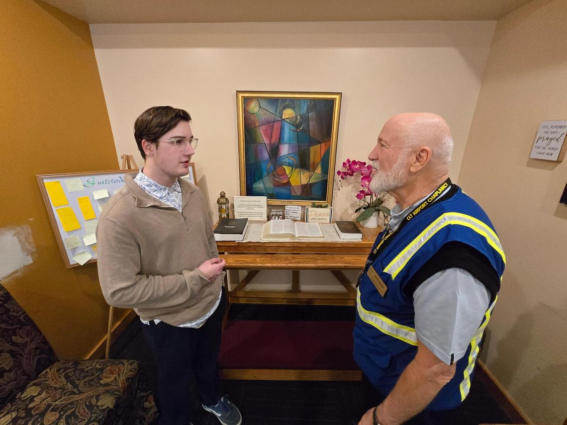 Wilmington resident Foster Jones visits with Chaplain David Reiser at interfaith chapel at Charlotte Douglas International Airport.