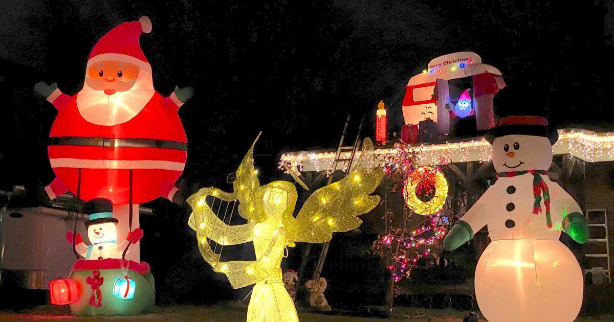 A home on Middlebury Place features Santa in an inflatable camper on its roof.