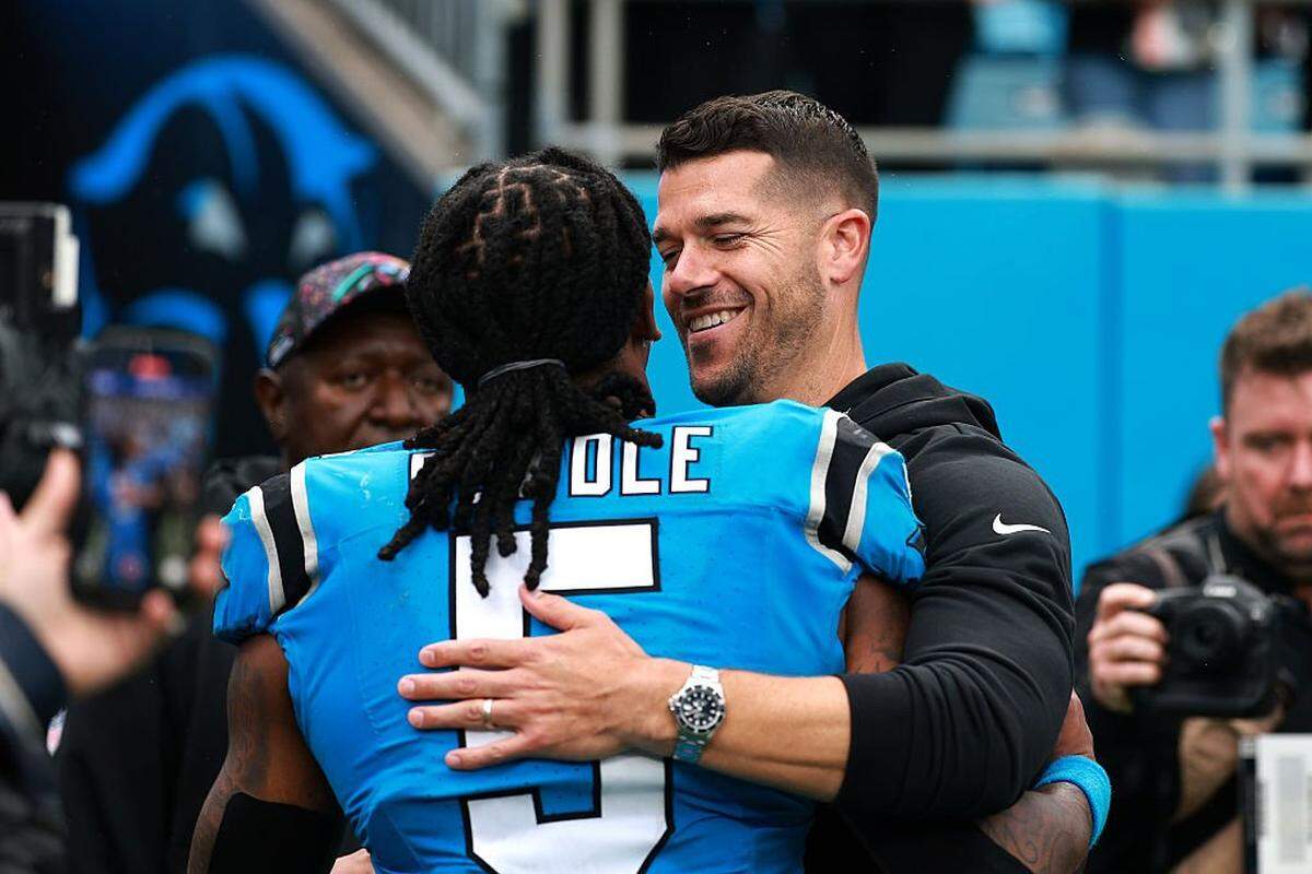 Rico Dowdle (5) and head coach Dave Canales of the Carolina Panthers hug after the game against the Dallas Cowboys at Bank of America Stadium on October 12, 2025 in Charlotte, North Carolina.