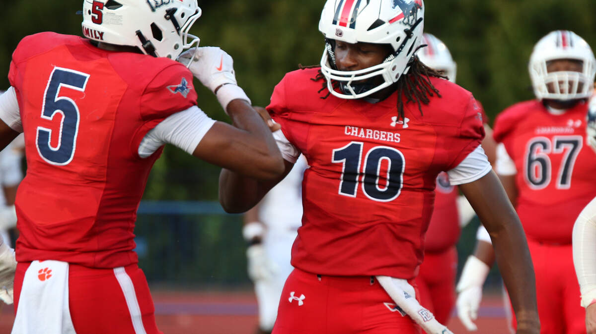 Providence Day quarterback Zaid Lott and WR Gordon Sellars high-five after a touchdown during Friday’s game with Roman Catholic (PA) at Providence Day School in Charlotte, NC on August 22,2025