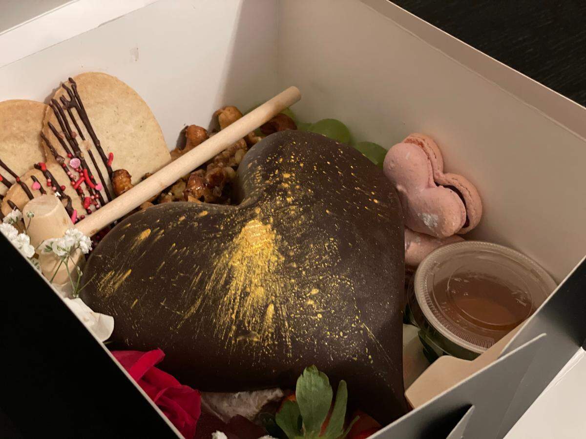 Off The Block’s Heartbreaker Box includes North Carolina-sourced meats and cheeses encased in a dark chocolate heart with side items, including Lemon Shortbread and Raspberry Macarons by Wentworth & Fenn.
