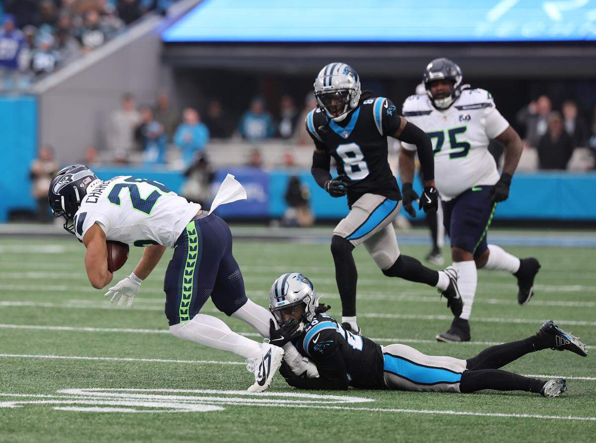 Carolina Panthers cornerback Chau Smith-Wade pulls down Seattle Seahawks running back Zach Charbonnet during the game on Sunday, Dec. 28, 2025 at Bank of America Stadium in Charlotte.