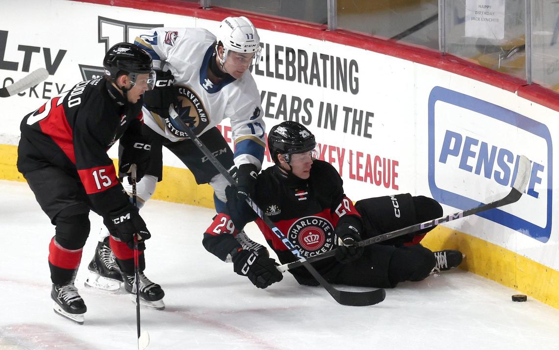 Charlotte Checkers Sandis Vilmanis, right, fights to gain control of the puck during action against the Cleveland Monsters at Bojangles Coliseum in Charlotte, NC on Friday, October 18, 2024.