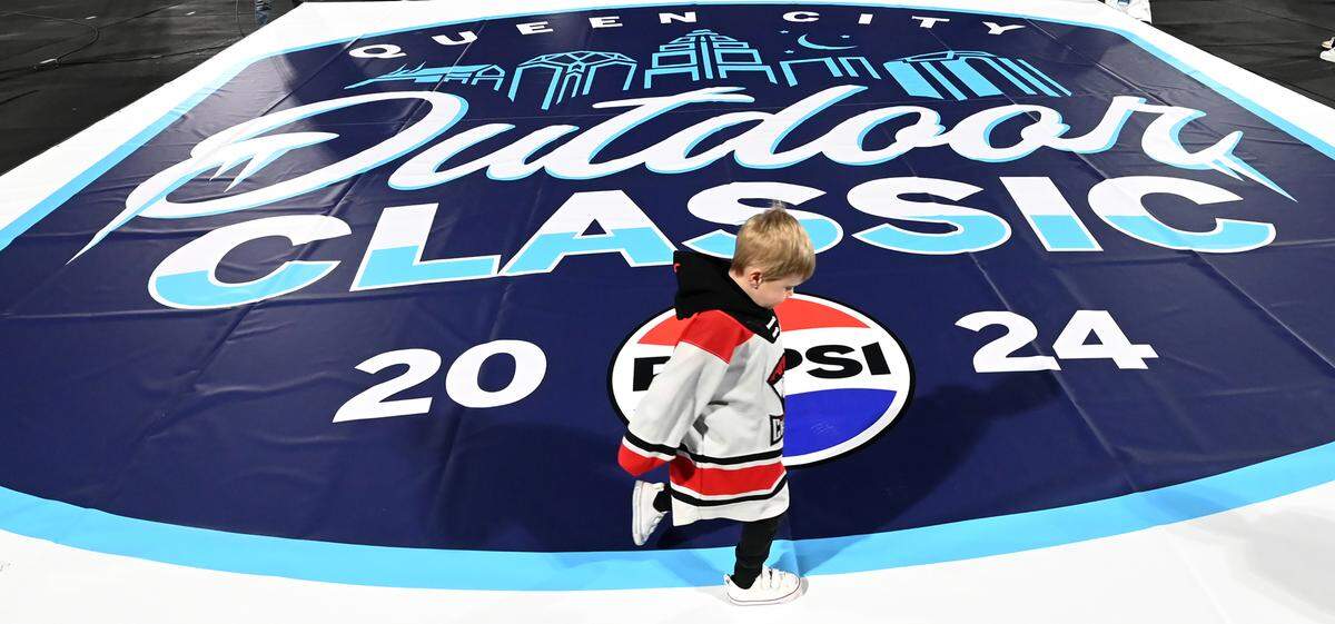 Charlotte Checkers forward Zac Dalpe’s 2-year-old son, Beckham Dalpe, runs around the Queen City Outdoor Classic mural on the field at Truist Field in uptown Charlotte, NC on Saturday, January 13, 2024. The classic featured the Charlotte Checkers vs the Rochester Americans.