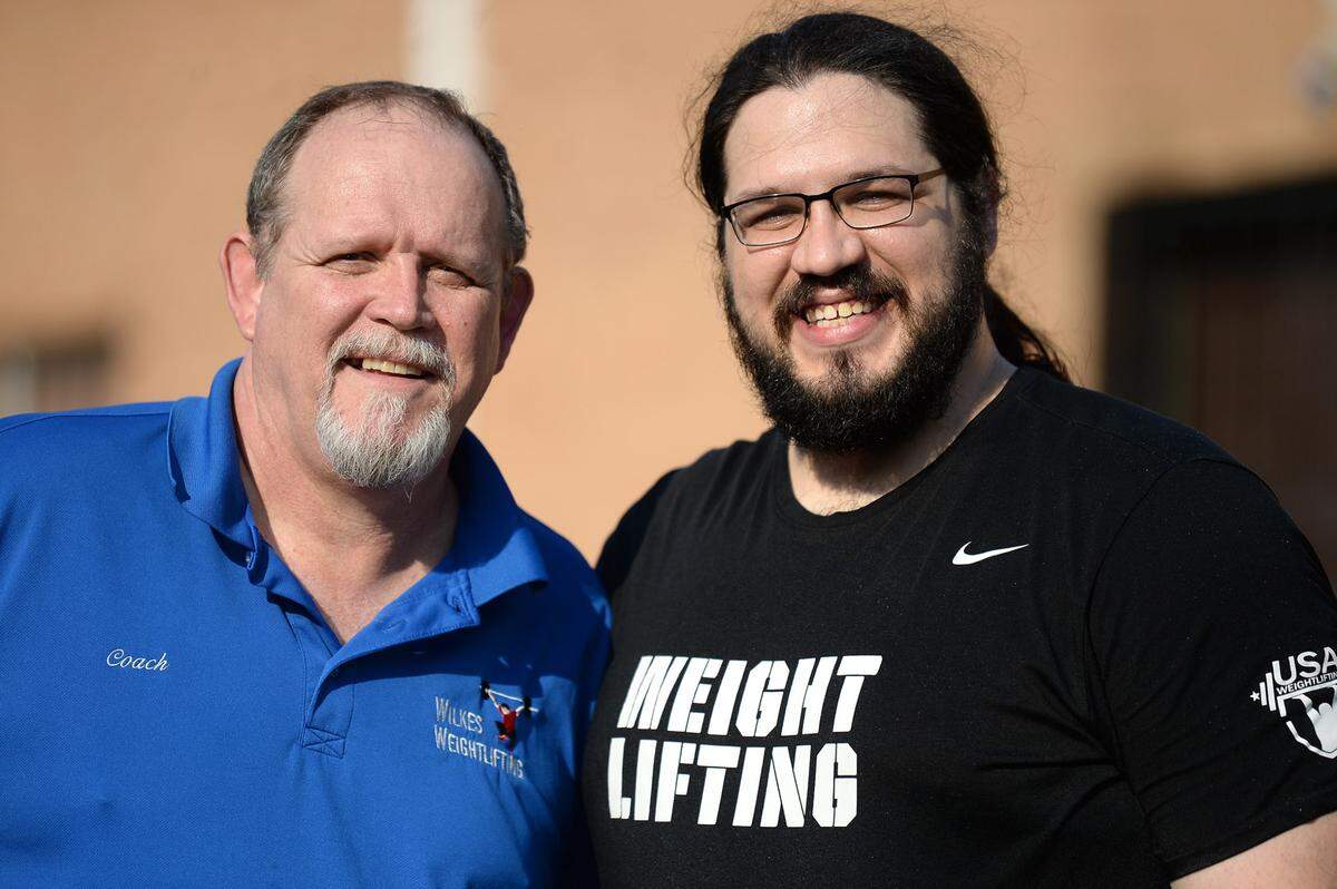 Chris Wilkes, left, was once a homicide detective in Virginia. Now he coaches his son, Caine Wilkes, an Olympic weightlifter.