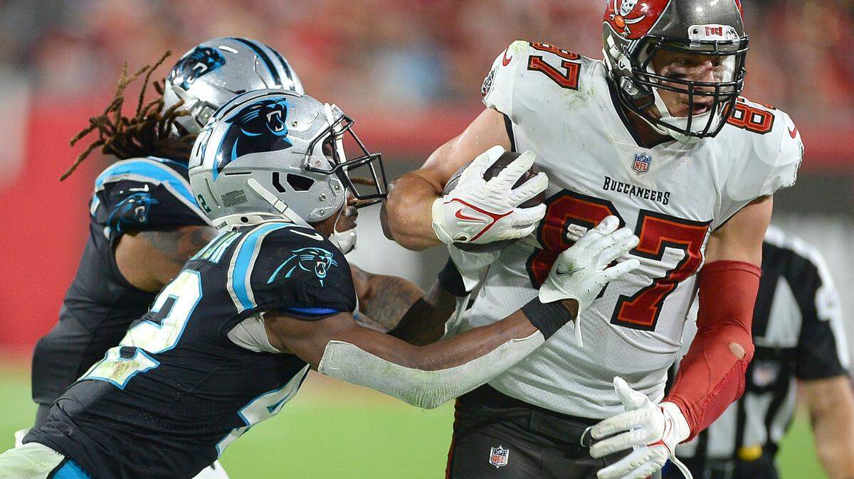 Carolina Panthers defenders try to stop Tampa Bay Buccaneers tight end Rob Gronkowski, right, following a pass reception during fourth quarter action at Raymond James Stadium in Tampa, Fl. on Sunday, January 9, 2022. The Panthers lost to the Buccaneers 41-17.