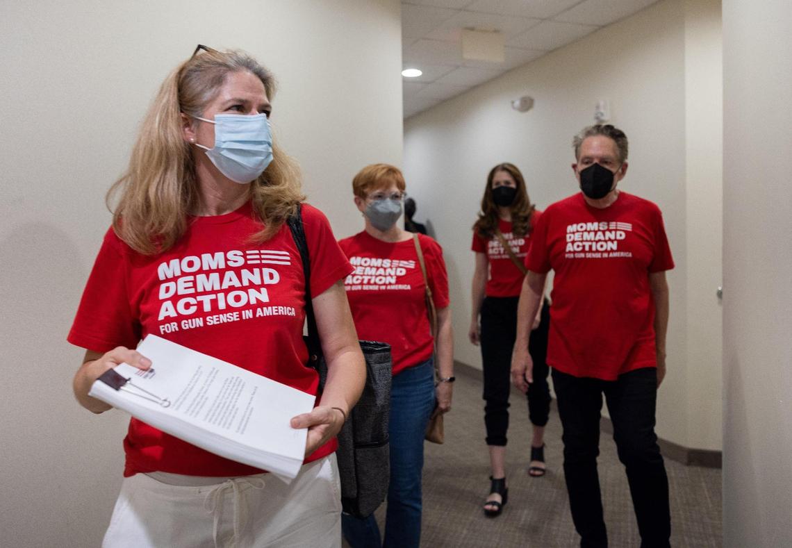 Shannon Klug with Moms Demand Action and Students Demand Action drops off a stack of petitions at the Charlotte office of U.S. Sen. Thom Tillis on Thursday.