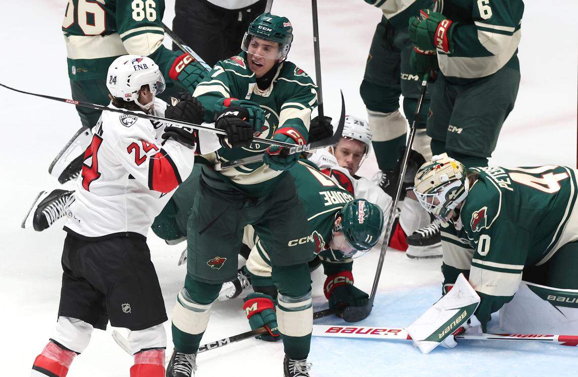 The Charlotte Checkers and Iowa Wild get tangled up in a scuffle during second period action on Friday, October 17, 2025 at Bojangles Coliseum in Charlotte, NC. 