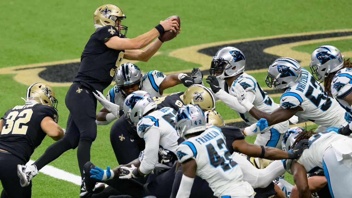 New Orleans Saints quarterback Drew Brees (9) scores against the Carolina Panthers in the second quarter on Oct. 25th with a leap over the top of the pile.