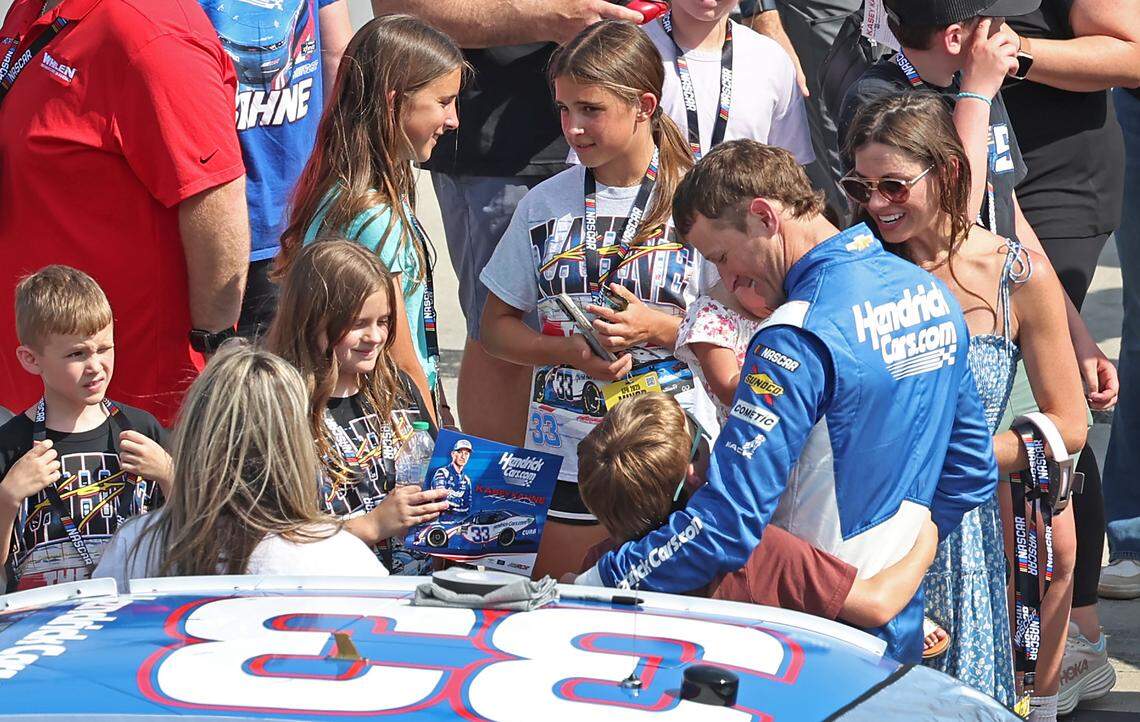 NASCAR Xfinity Series driver Kasey Kahne, right, is given best wishes prior to climbing into his car for the North Carolina Education Lottery 250 at Rockingham Speedway on Saturday, April 19, 2025.
