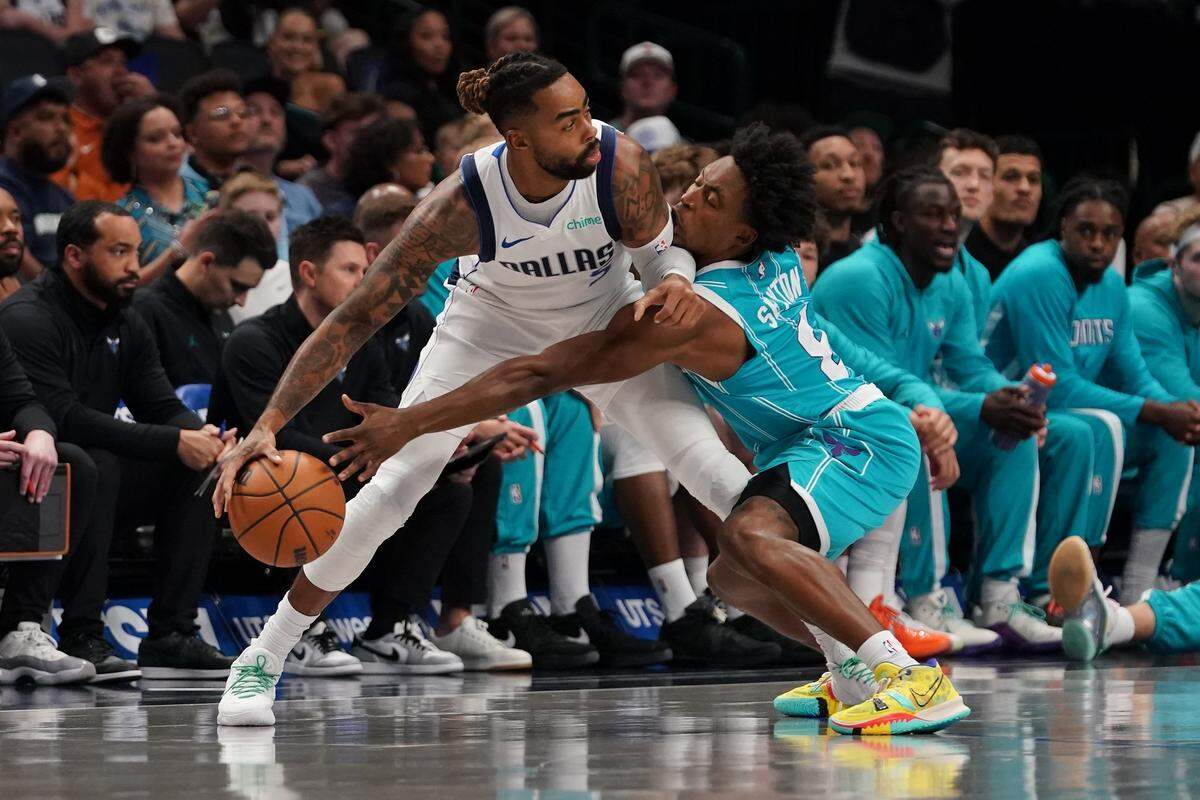 Dallas Mavericks guard D’Angelo Russell (5) is defended by Charlotte Hornets guard Collin Sexton (8) in the first half of a game at American Airlines Center.
