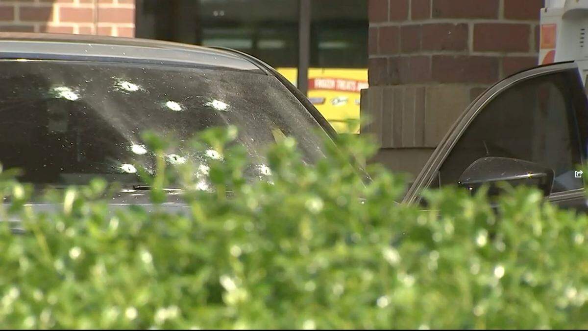 In this image from WSOC video, a black Mazda 6 with several bullet holes in its windshield sits at a gas pump after a shooting on Tuesday, May 31, 2022.
