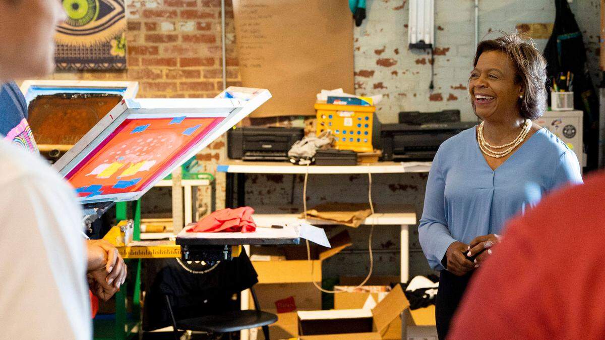 U.S. Senate candidate Cheri Beasley speaks with employees of MacFly Fresh Printing Co. at Camp North End in Charlotte on June 9, 2021. Beasley talked with various business owners about the effect COVID-19 had on their establishments and how a representative could help change it.