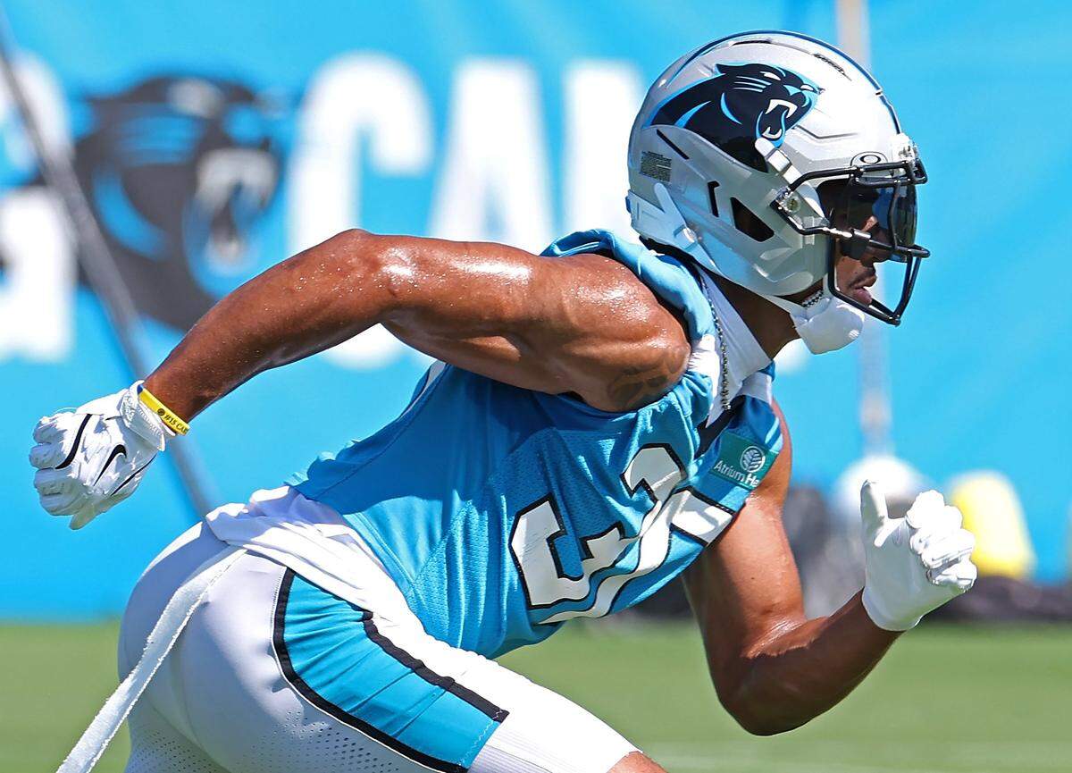 Carolina Panthers running back Chuba Hubbard breaks off the line to take a handoff during a training camp practice on July 23, 2025. 