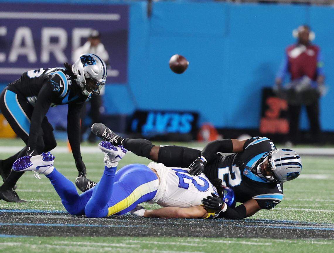 Carolina Panthers cornerback Chau Smith-Wade (26) and Mike Jackson (2) take down Los Angeles Rams wide receiver Puka Nacua he wild card playoff game against the Rams at Bank of America Stadium on Saturday, Jan. 10, 2025 in Charlotte