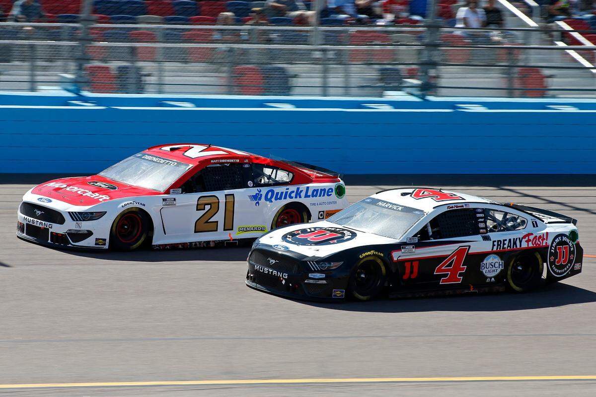 Kevin Harvick (4) and Matt Dibenedetto (21) race through Turn 4 during a NASCAR Cup Series auto race at Phoenix Raceway, Sunday, March 14, 2021, in Avondale, Ariz. (AP Photo/Ralph Freso)