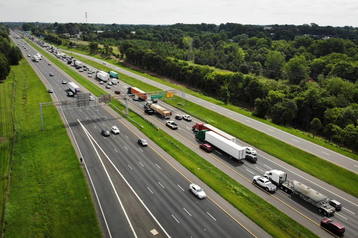 Motorists travel along Interstate 77 near Arrowood Road in Charlotte, N.C., Thursday, July 21, 2022. NCDOT received a proposal from a private firm suggesting a public-private partnership to build toll lanes on I-77, from Brookshire Freeway/I-277 to the South Carolina border.