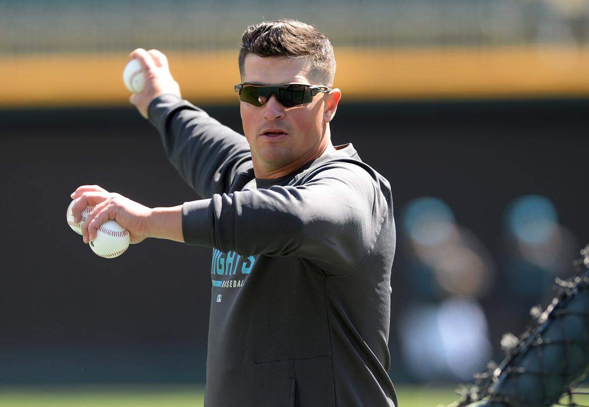 Charlotte Knights manager Justin Jirschele pitches batting practice during the team’s media day on Wednesday, March 29, 2023 at Truist Field in Charlotte, NC.