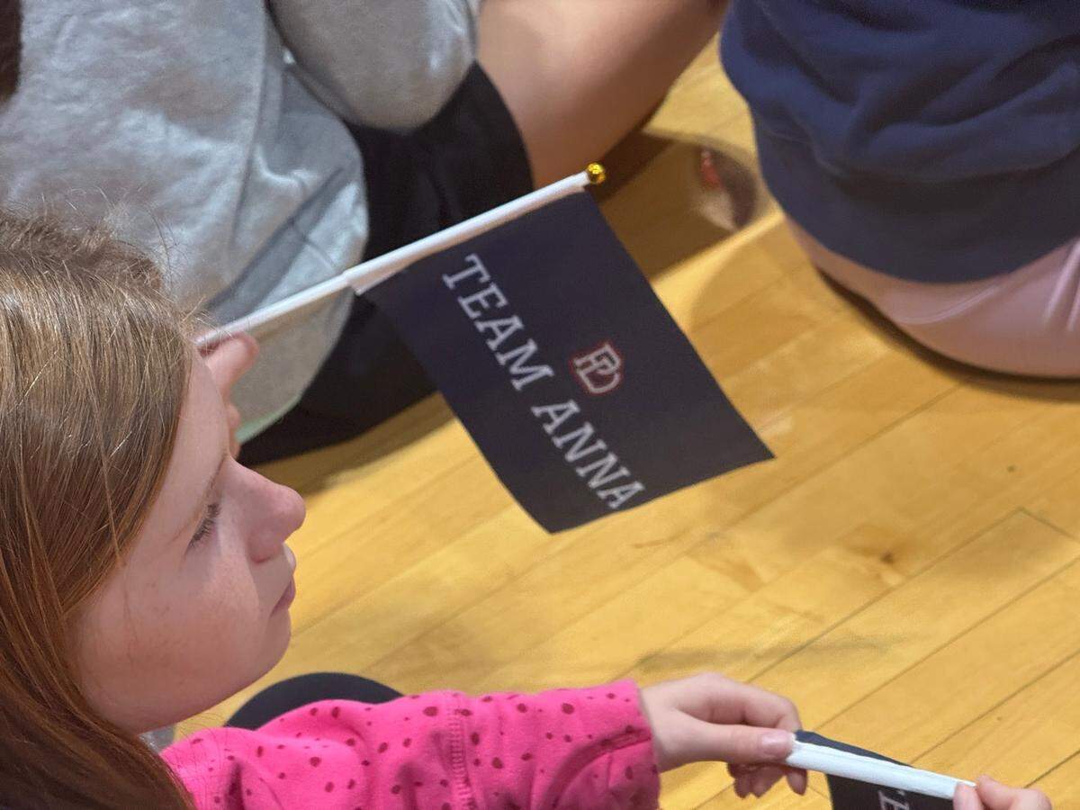 Students at Providence Day were given flags to celebrate U.S. Olympic silver medalist Anna Cockrell, who graduated from the school eight years ago.