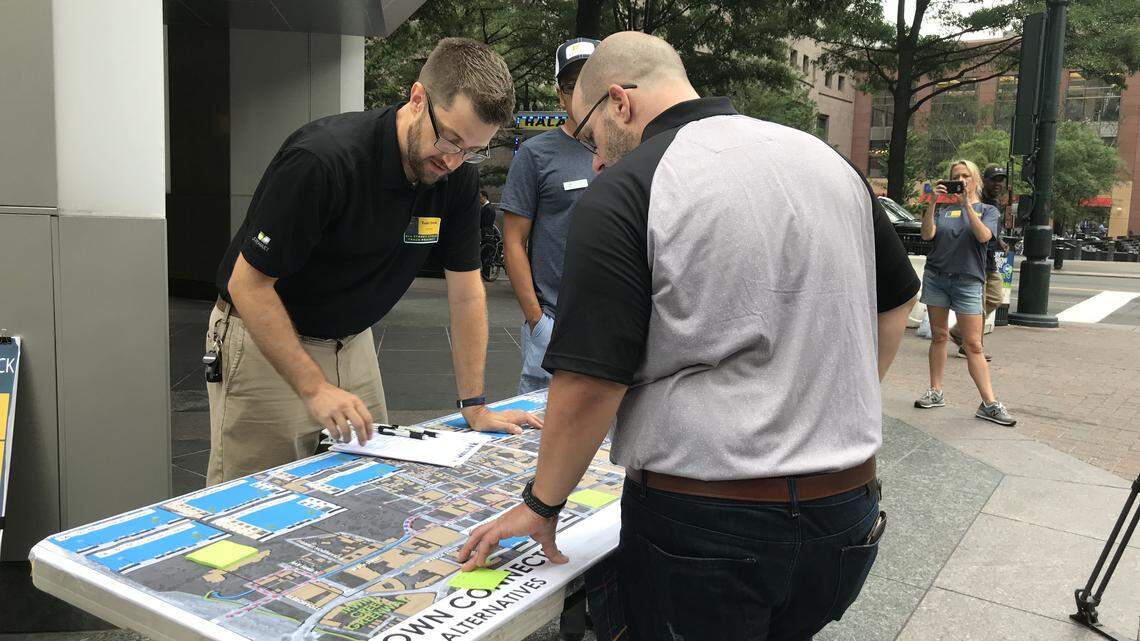 Engineer Todd Delk, left, discusses plans for an uptown cycle track to Charlotte resident Randy Furr.