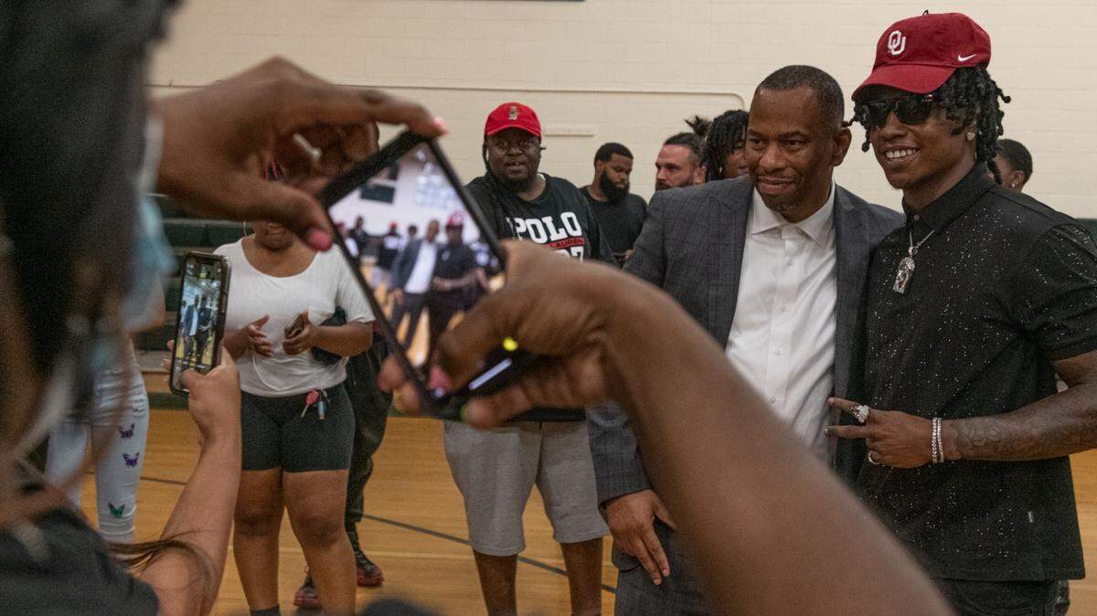 Former Chambers High running back Daylan Smothers, the No. 1 running back recruit in North Carolina this year, poses with friends, family and coaches after announcing the University of Oklahoma as his college choice during a commitment ceremony held at Ranson Middle School in Charlotte on Thursday.