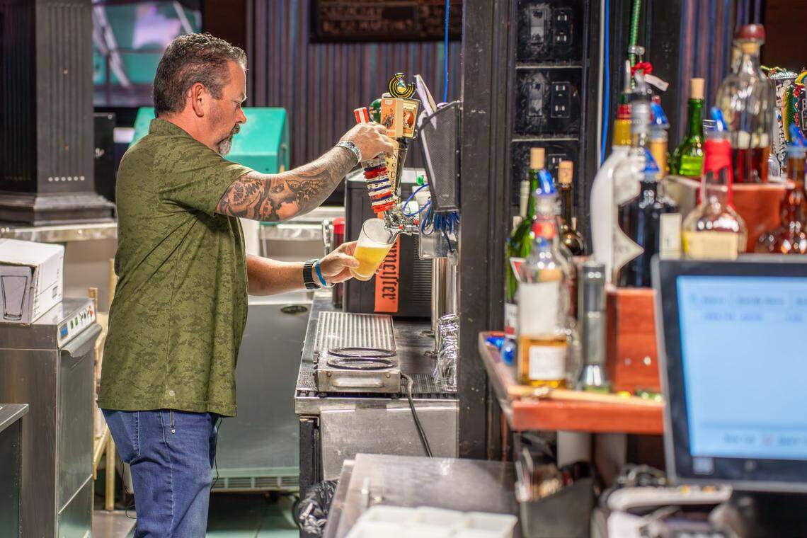 Kristophers owner Robby Stringer pours a beer inside the sports bar.