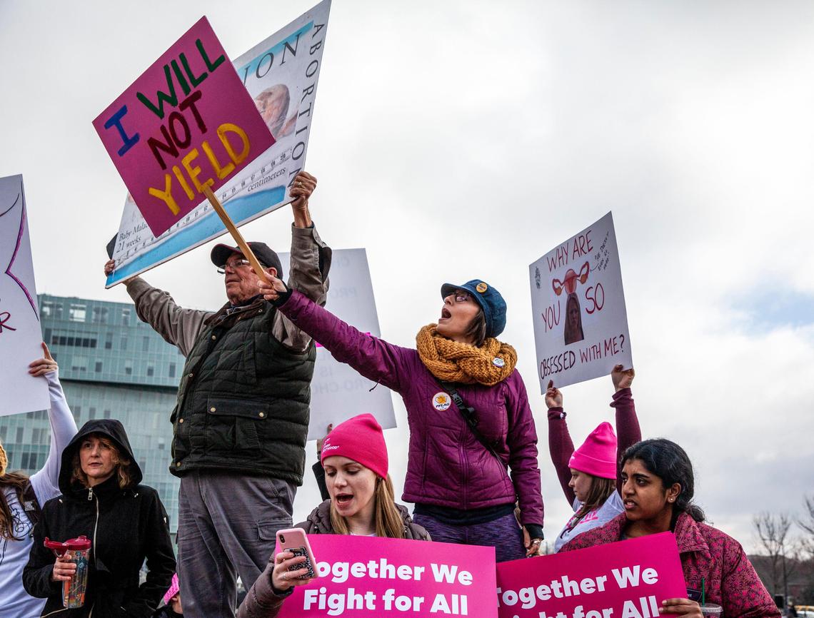 Candice Todd, 34, is blocking a protester’s anti-abortion sign at the 2020 Women United March in uptown Charlotte on Saturday, January 25, 2020