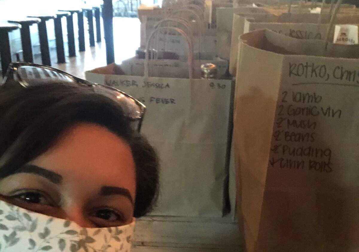 Haberdish manager Moriah Glenn hands out Easter brunch pre-orders on Sunday, April 12, 2020. The restaurant team members are all wearing masks now in both front and back of house. The masks were handmade by one of the team members.