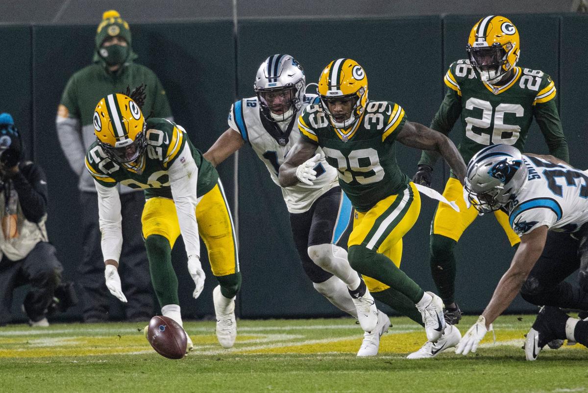 Green Bay Packers cornerback Kevin King (20) picks up a fumble by Carolina Panthers Teddy Bridgewater during an NFL football game, Saturday, Dec 19. 2020, between the Carolina Panthers and Green Bay Packers in Green Bay, Wis. (AP Photo/Jeffrey Phelps)