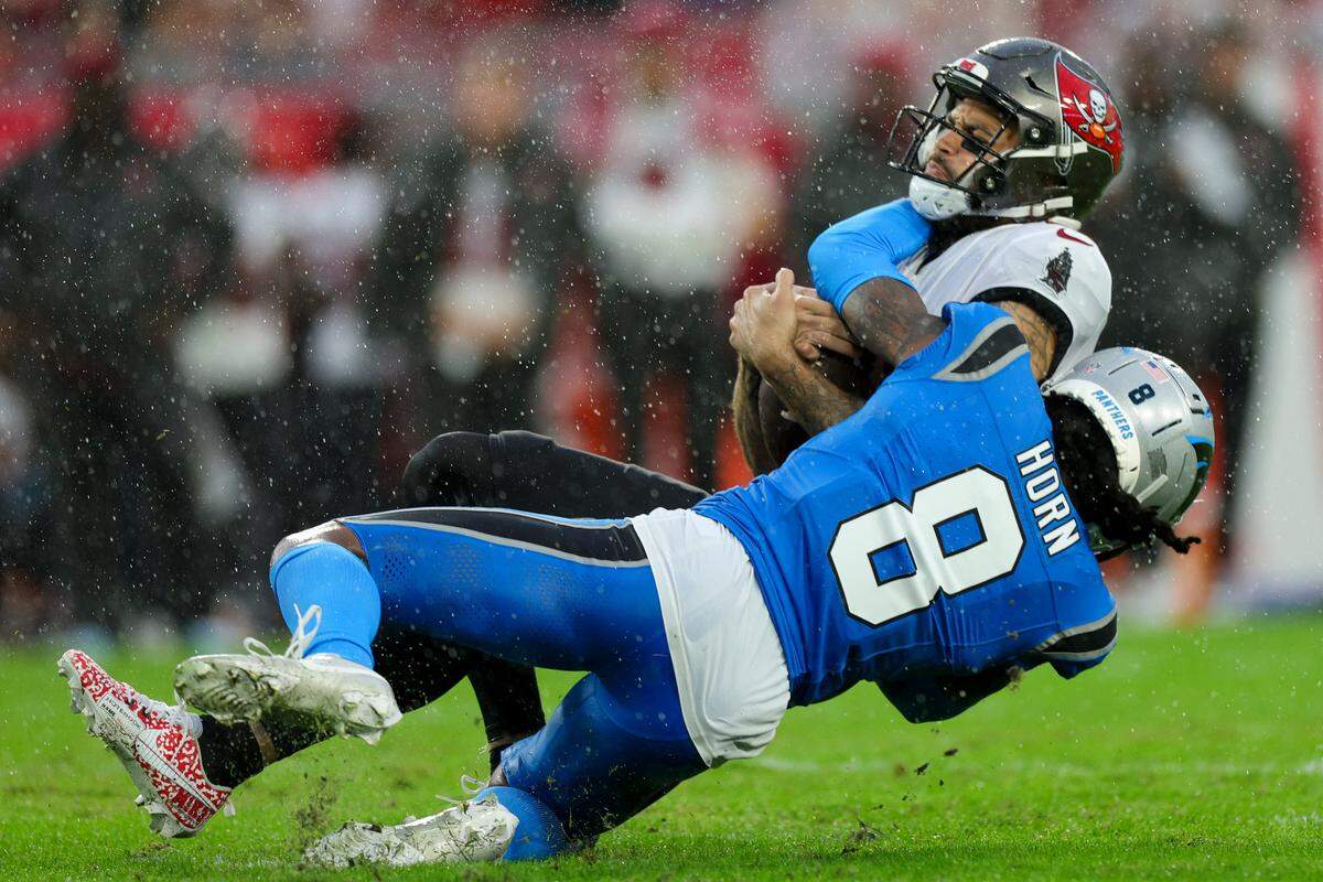Dec 3, 2023; Tampa, Florida, USA; Tampa Bay Buccaneers wide receiver Mike Evans (13) is tackled by Carolina Panthers cornerback Jaycee Horn (8) in the second quarter at Raymond James Stadium. Mandatory Credit: Nathan Ray Seebeck-USA TODAY Sports