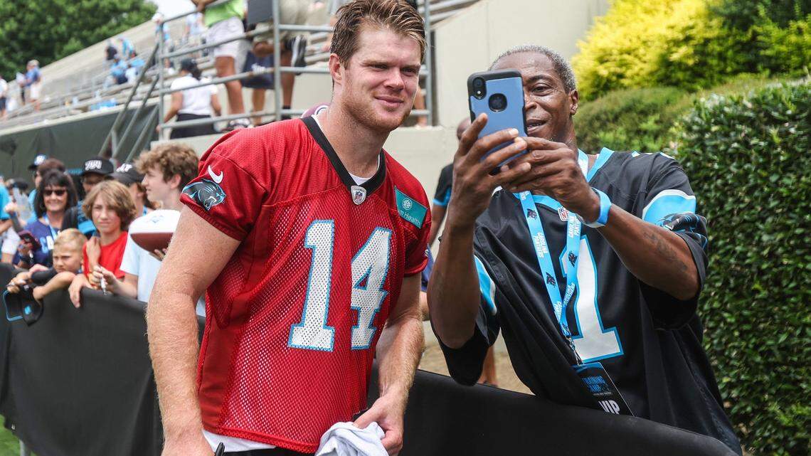 Panthers quarterback Sam Darnold, left, poses for a selfie with a fan after the Back Together practice in Gibbs Stadium at Wofford College on Saturday, July 30, 2022 in Spartanburg, SC.