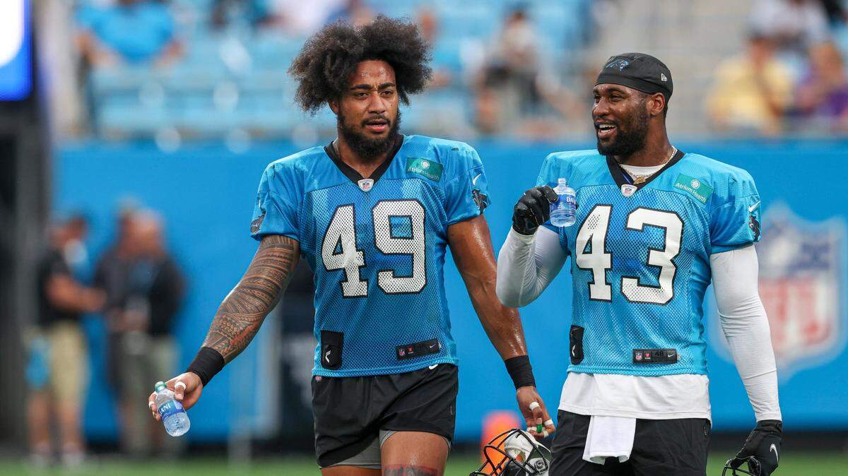 Carolina Panthers linebackers Frankie Luvu (49) and Haason Reddick (43) talk during the team’s Fan Fest practice in Charlotte on Aug. 6th. Both players joined the team during the offseason.