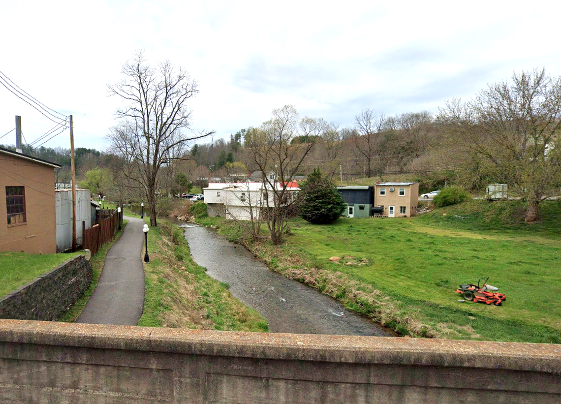 The white building to the right of Cane Creek is the back of Helen’s Restaurant, shown before Hurricane Helene arrived in Bakersville, North Carolina.