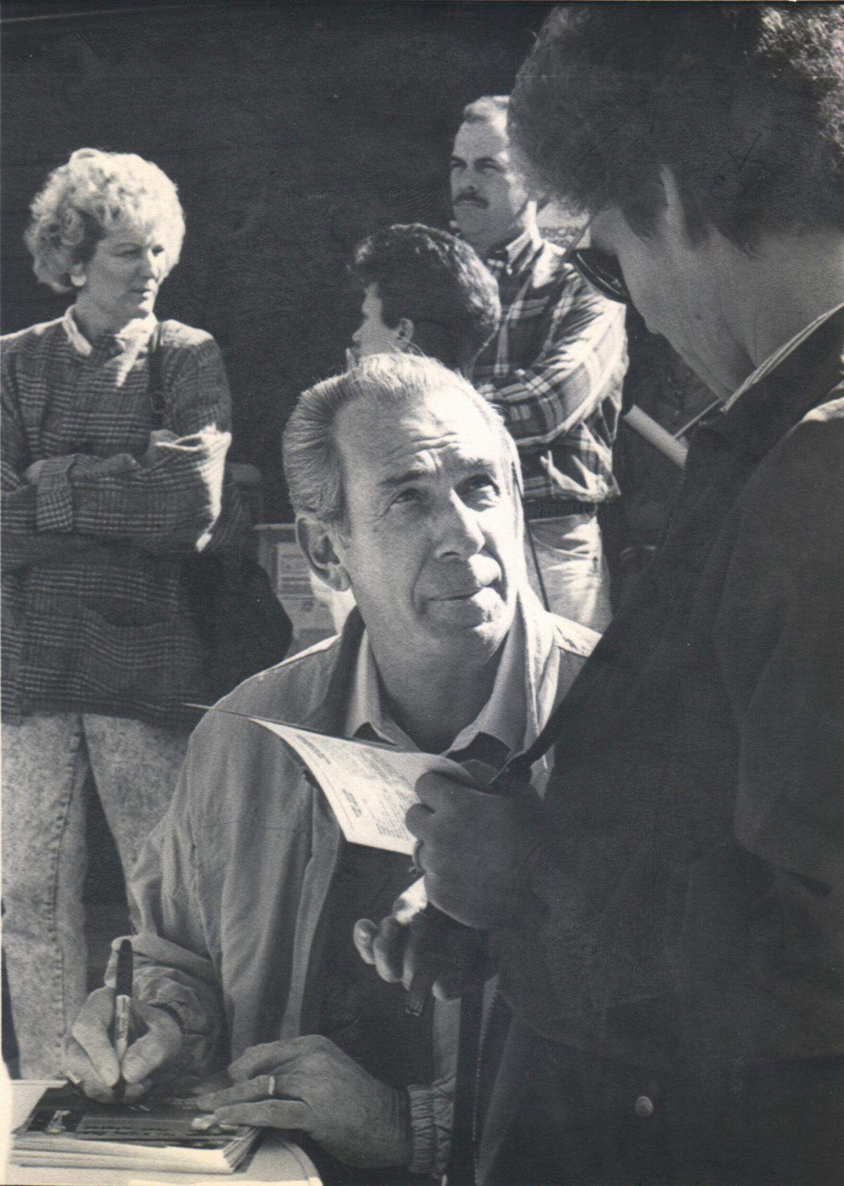 Retired NASCAR driver Ned Jarrett signs autographs for the fans at Tumbleweeds Steak House in Hickory, NC on Jan. 2, 1991. Observer File Photo