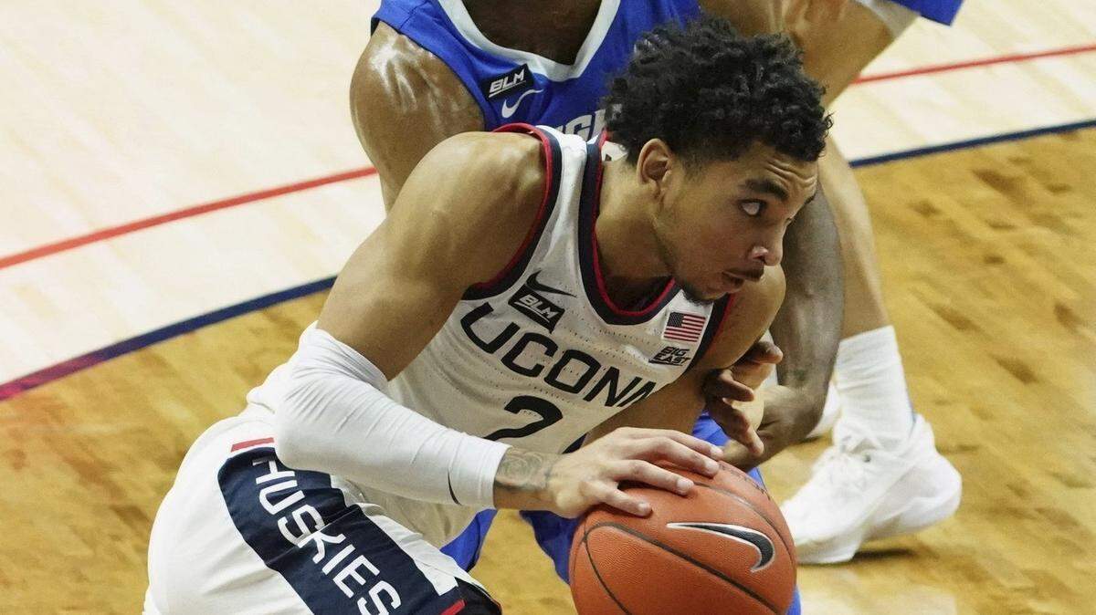 Connecticut guard James Bouknight (2) drives the ball against Creighton guard Denzel Mahoney (34) in the second half of an NCAA college basketball game in Storrs, Conn., Sunday, Dec. 20, 2020. (David Butler II/Pool Photo via AP)